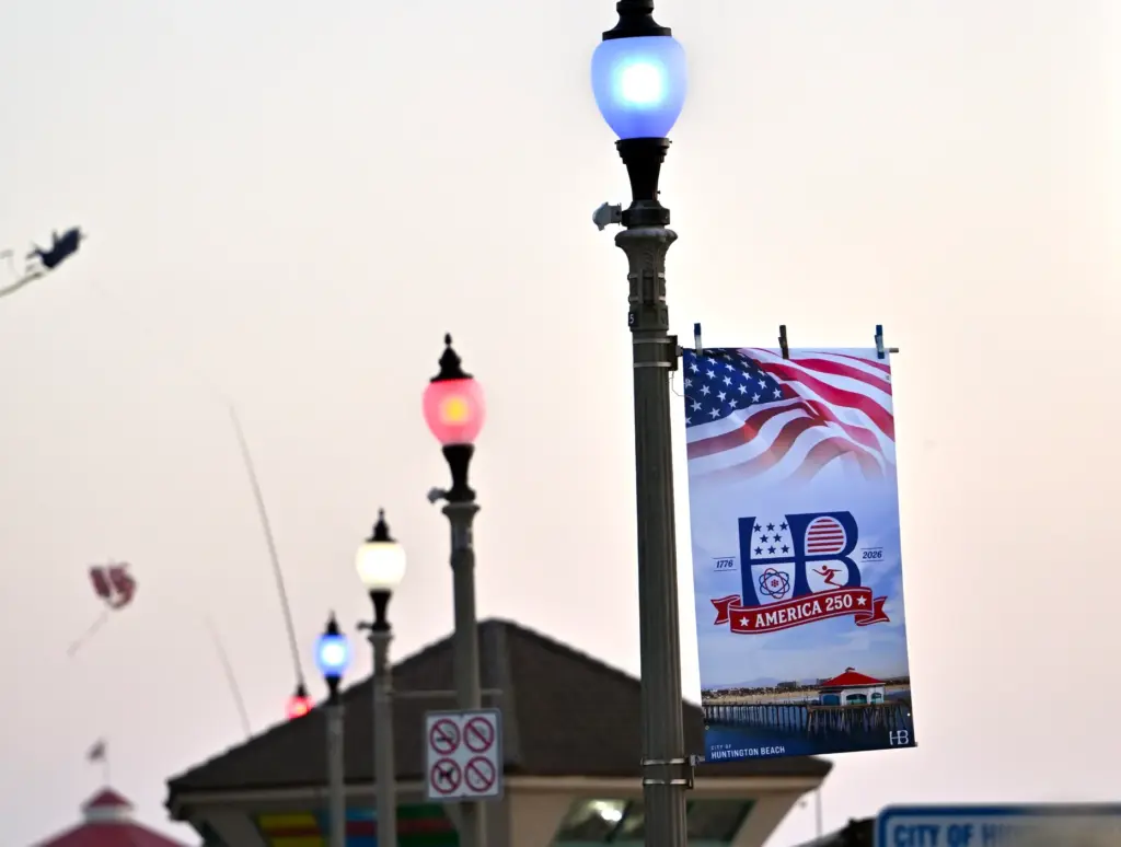 A new HB America 250 commemorative banner hangs among red,...