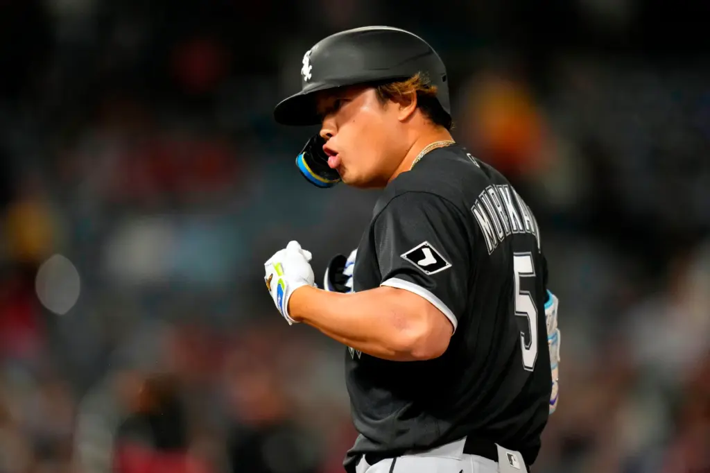 Chicago White Sox slugger Munetaka Murakami gestures to his dugout...