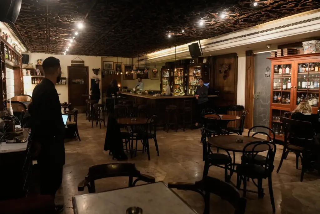 People spend time at an almost empty bar on Hamra Street in Beirut.