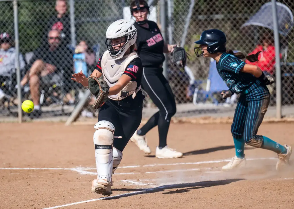 San Clemente catcher Havyn Nekritz fields a wide throw to...