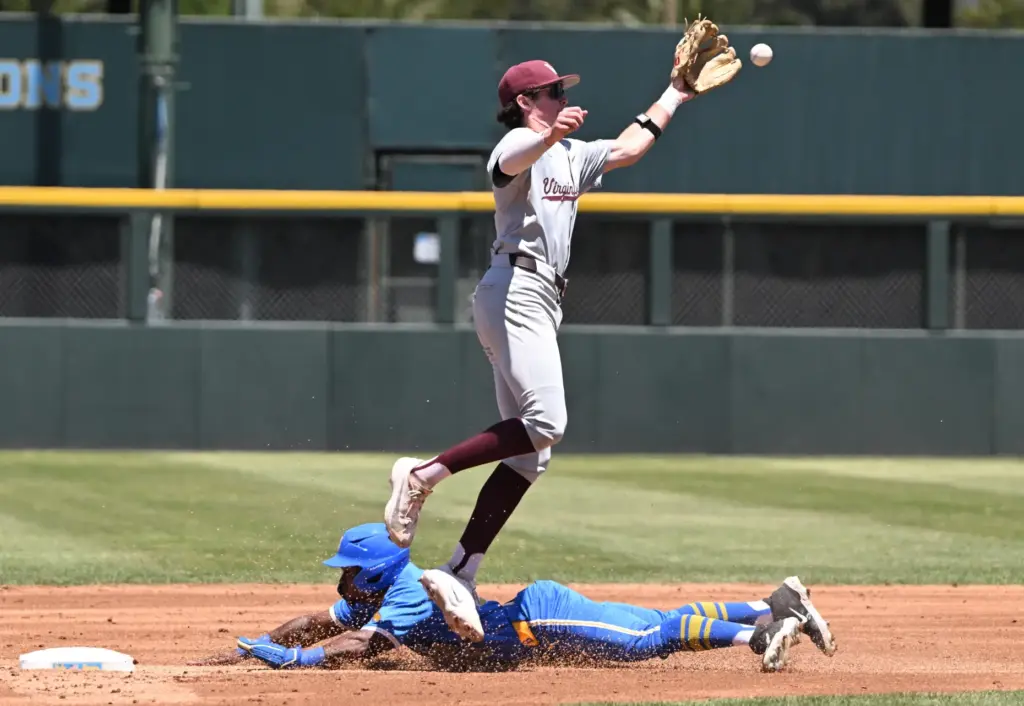 Dean West #36 of the UCLA Bruins steals second base...