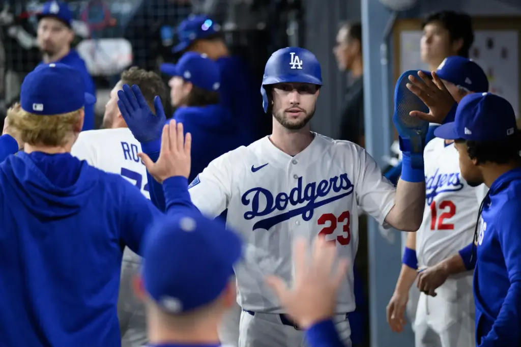 The Dodgers’ Kyle Tucker is greeted in the dugout after...