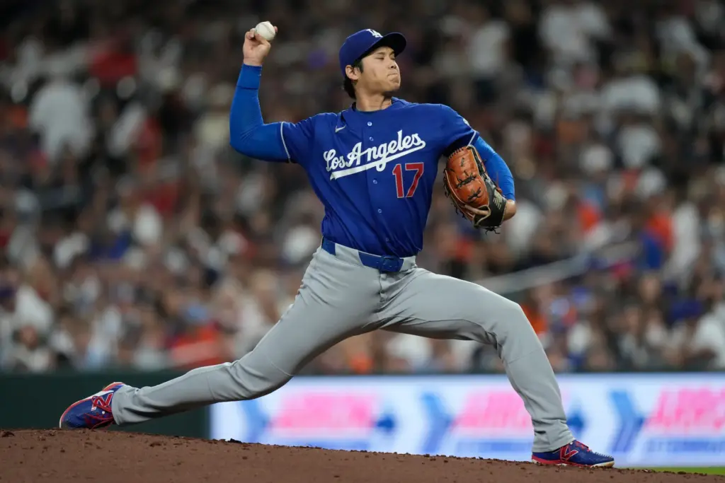 Dodgers starting pitcher Shohei Ohtani throws to the plate during...
