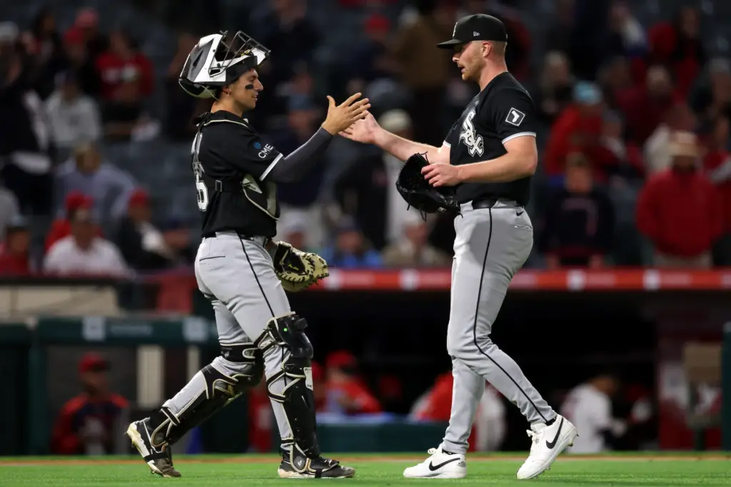 Chicago White Sox catcher Drew Romo, left, and relief pitcher...