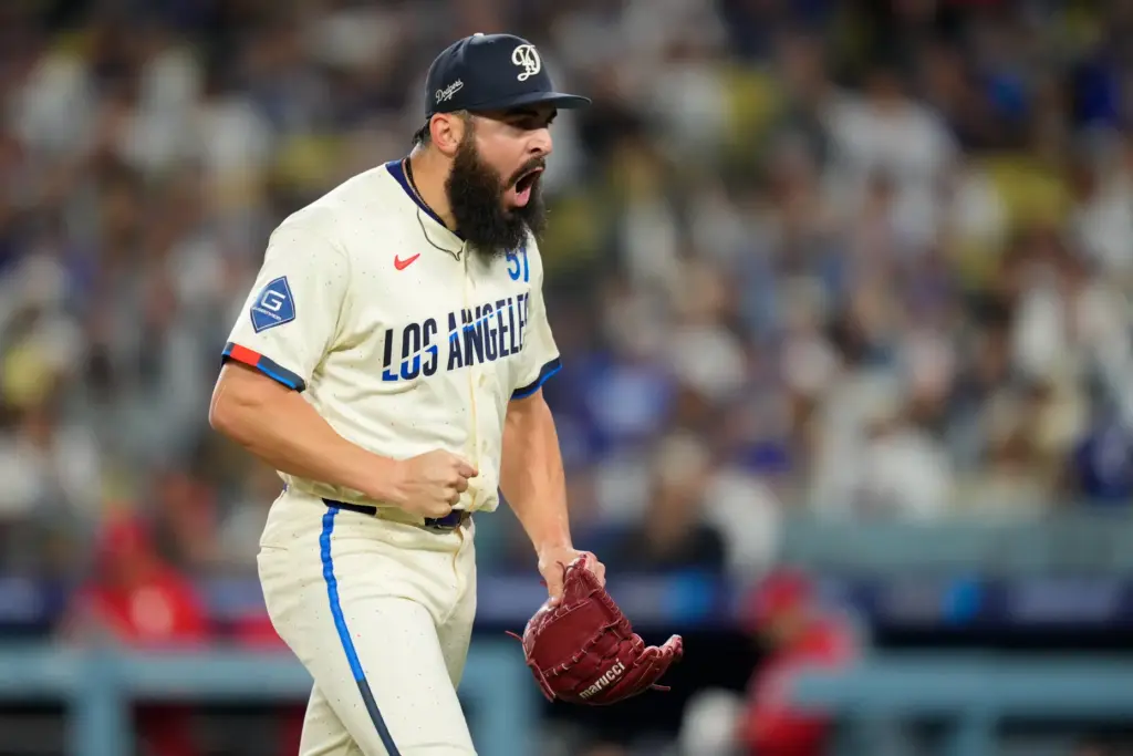 Dodgers pitcher Alex Vesia celebrates after finishing up the top...