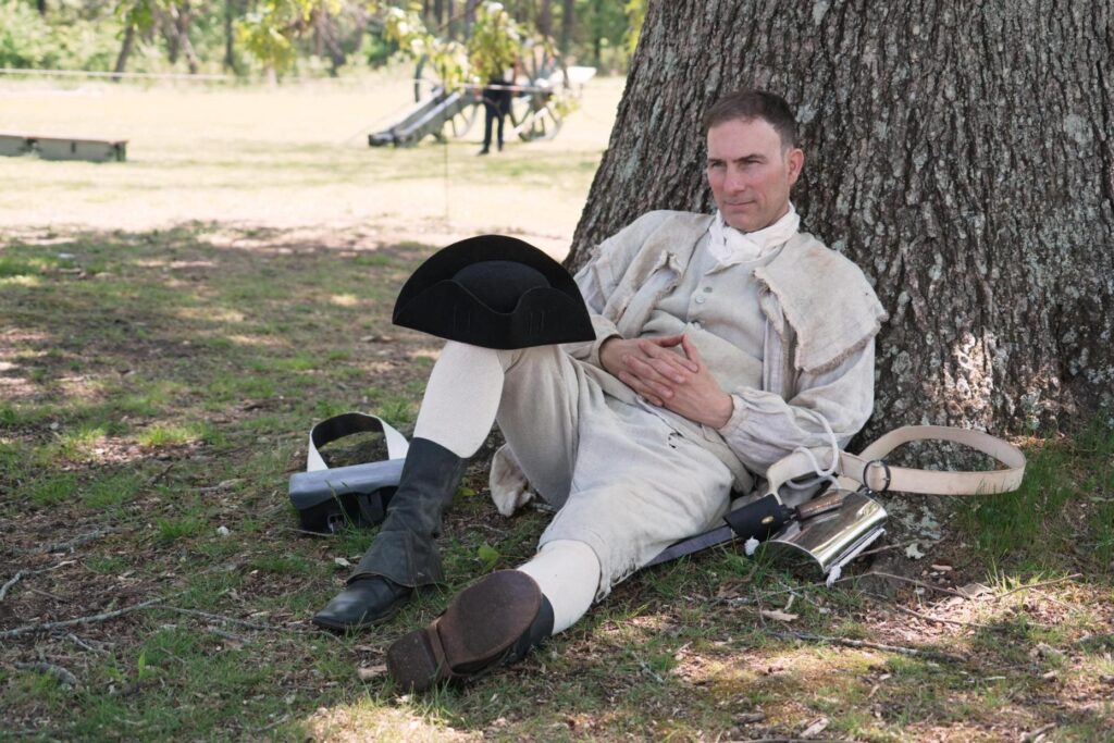 Army officer Jason Monhollen rests beneath a tree during a...