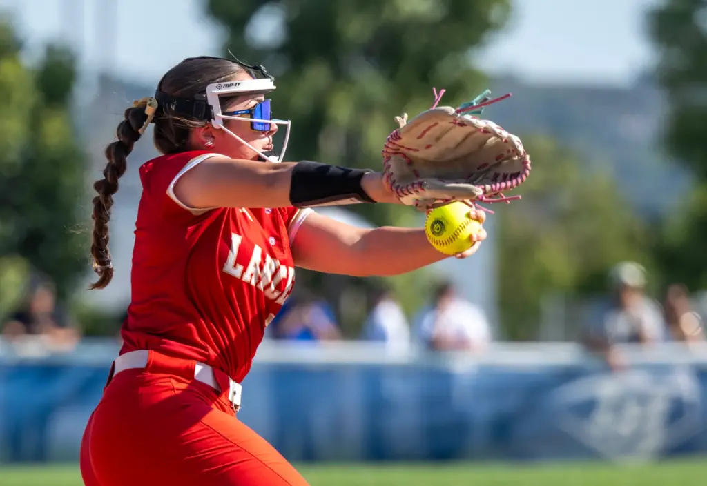 Orange Lutheran relief pitcher Charlee Pierpont throws to home plate...