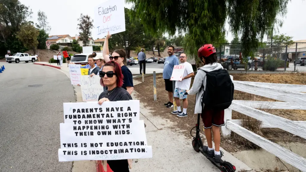 Protesters rally Friday, May 8, 2026, outside Canyon Hills Junior...