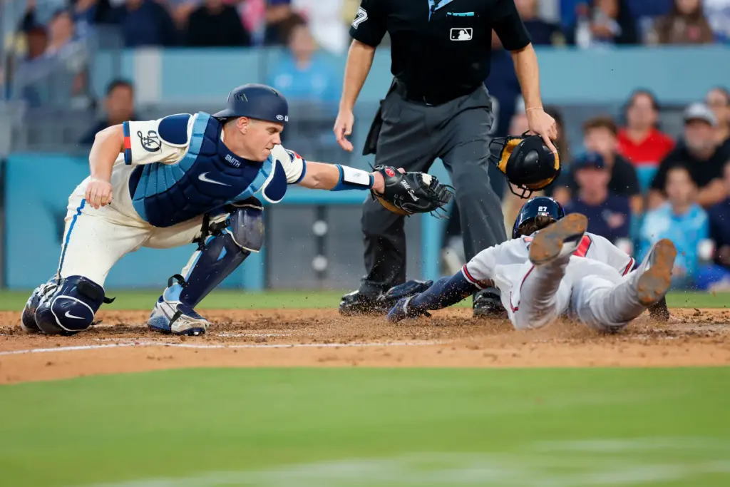 Atlanta Braves’ Austin Riley (27) slides into home plate to...