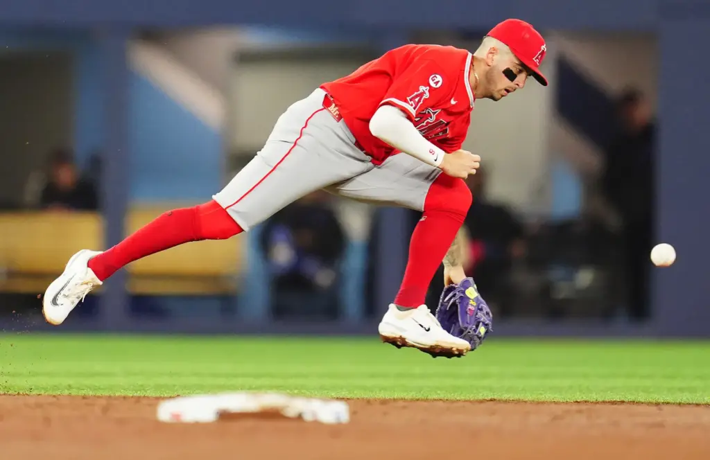 Angels shortstop Zach Neto can’t get to a ground ball...