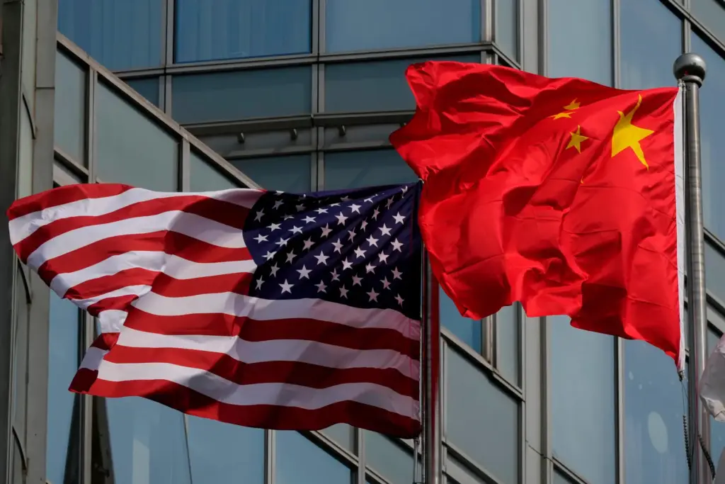 The United States and Chinese flags are flown outside a...