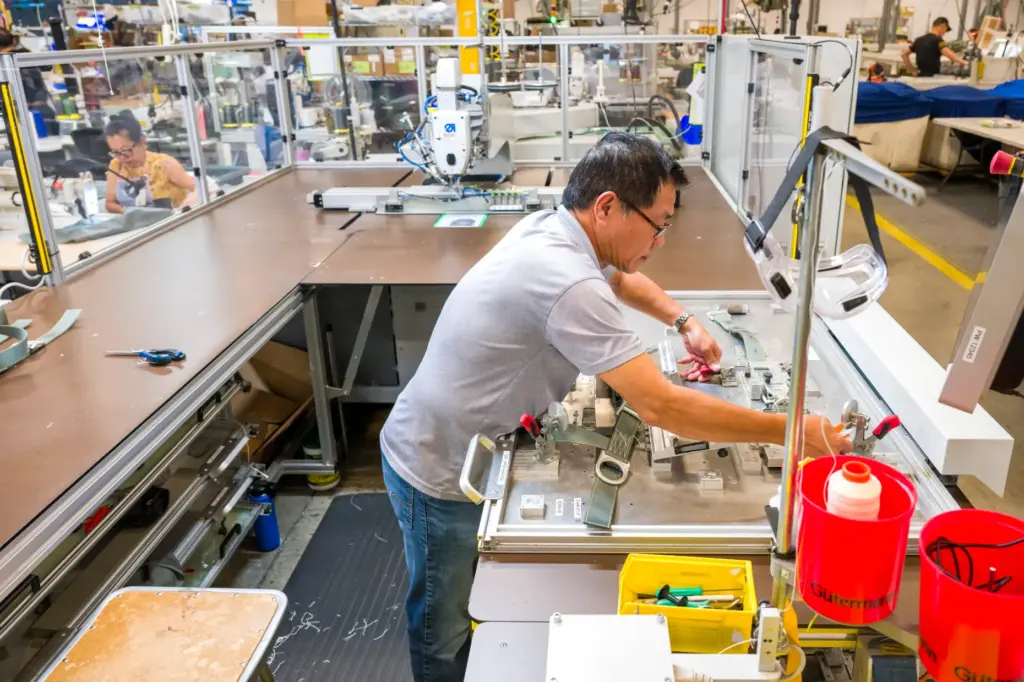 Assembler Quoc Anh Nguyen works on an automated pack tray...