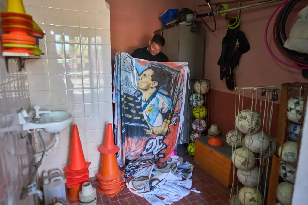 Jorge Sosa holds a flag featuring soccer star Lionel Messi