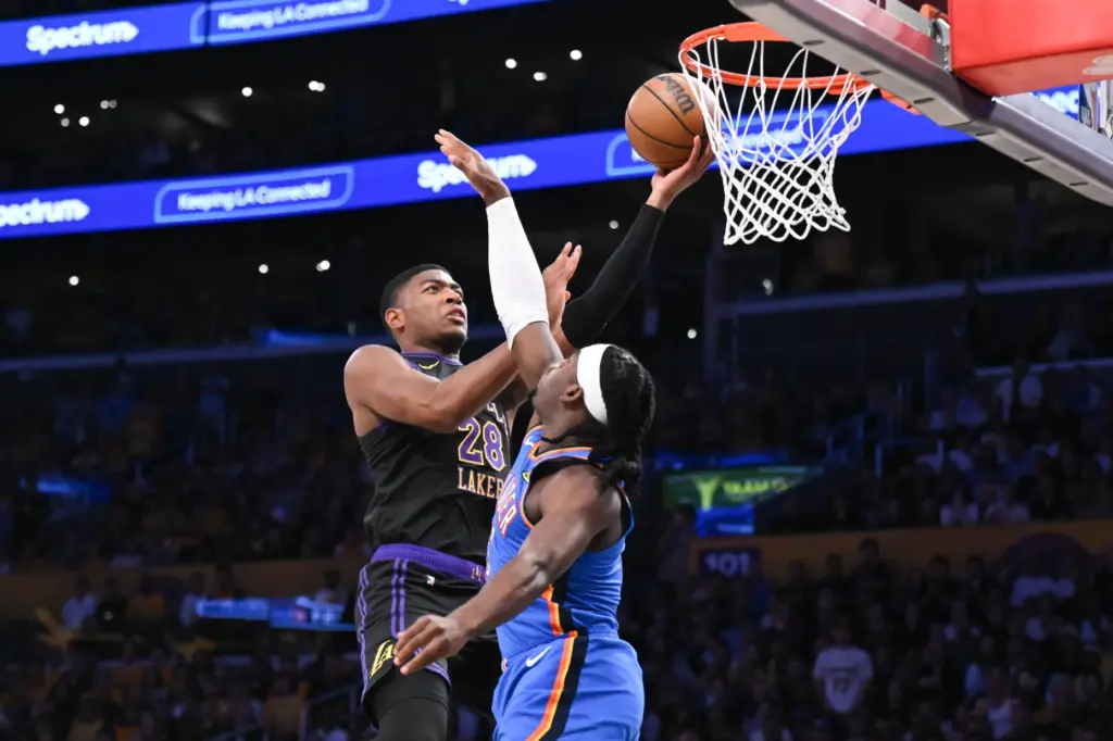 Lakers forward Rui Hachimura, left, gets to the basket for...