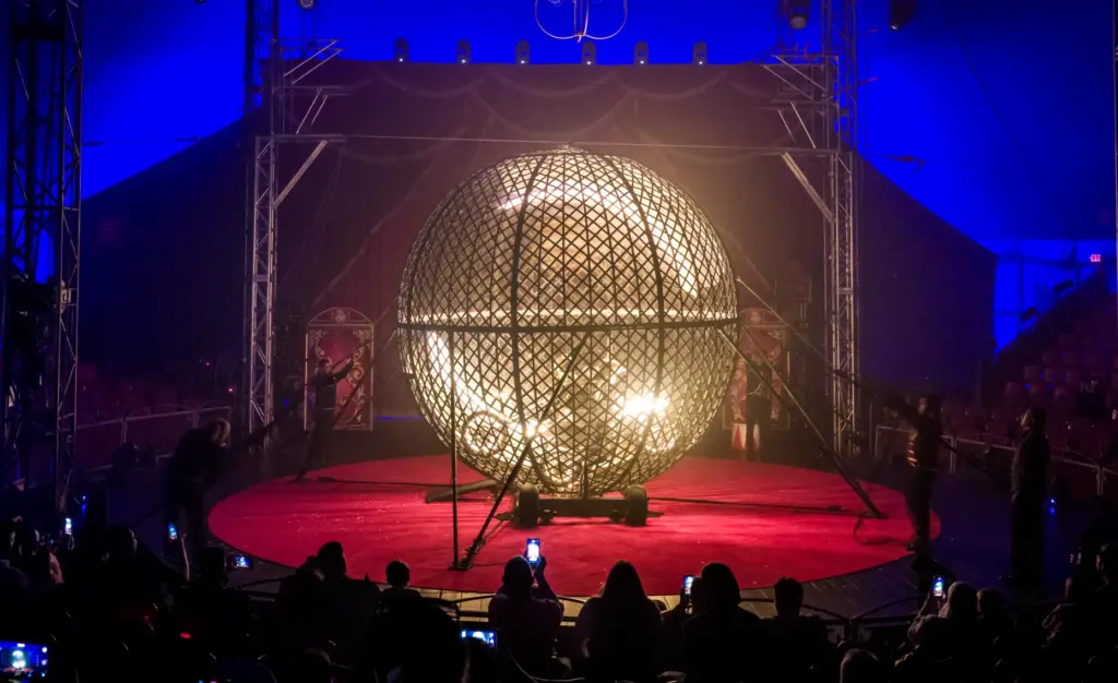 Four motorcycle riders zoom around the interior of âThe Globe...