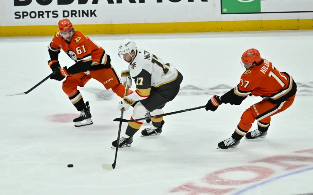 The Vegas Golden Knights’ Ben Hutton, center, controls the puck...