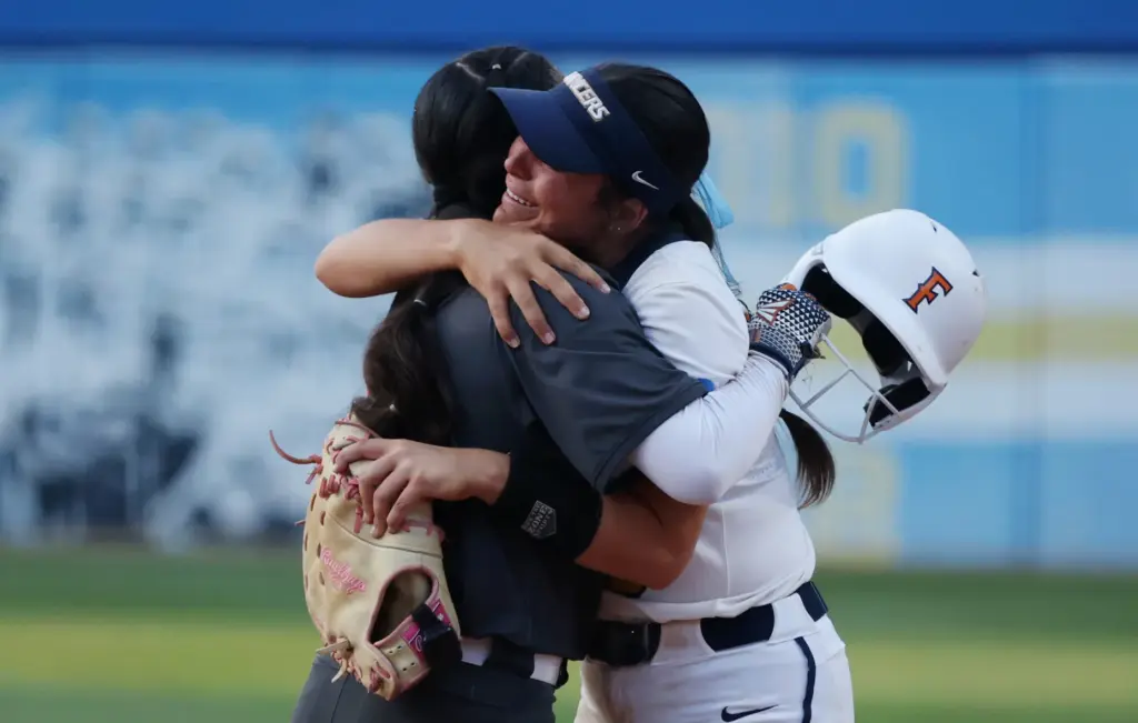 California Baptistâs Ashlee Annett, right, is embraced by Cal State...