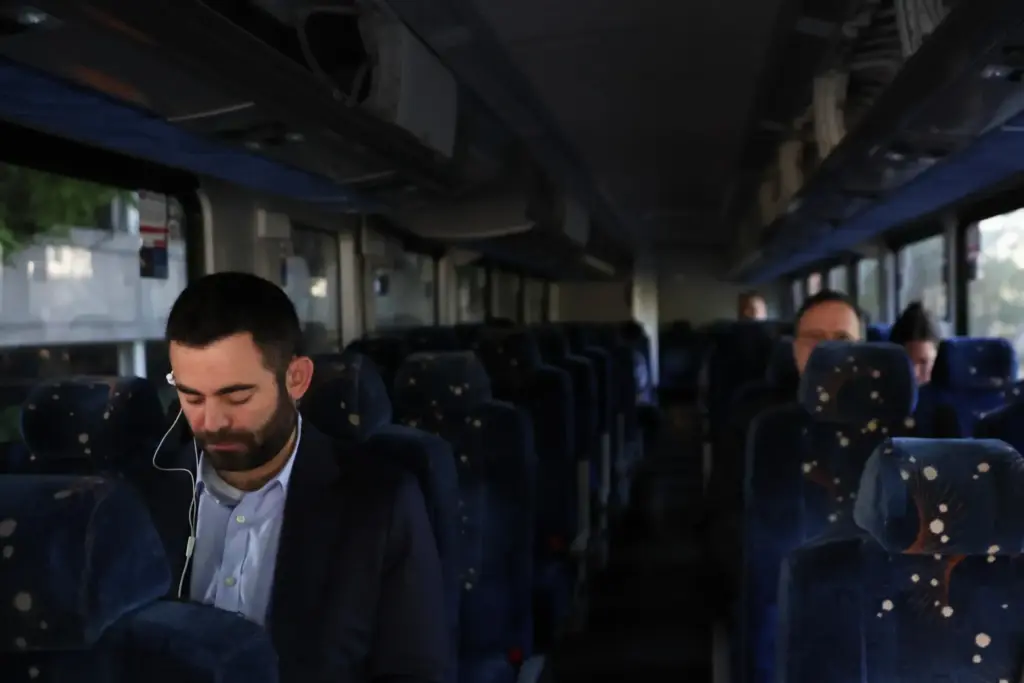 Commuters sit on a shuttle bus as Long Island Rail Road workers strike.