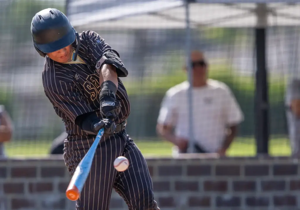 Servite catcher Jaden Liu hits a double in the top...