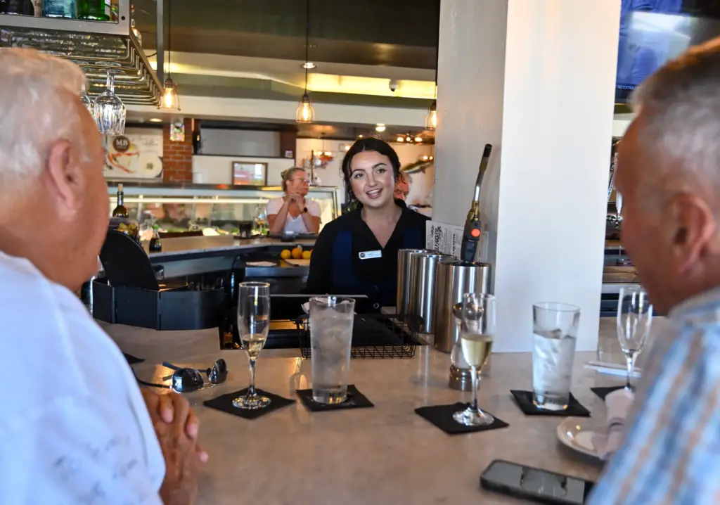Bartender Rhe Wilburn chats with regulars Ken Gibson and Steve...