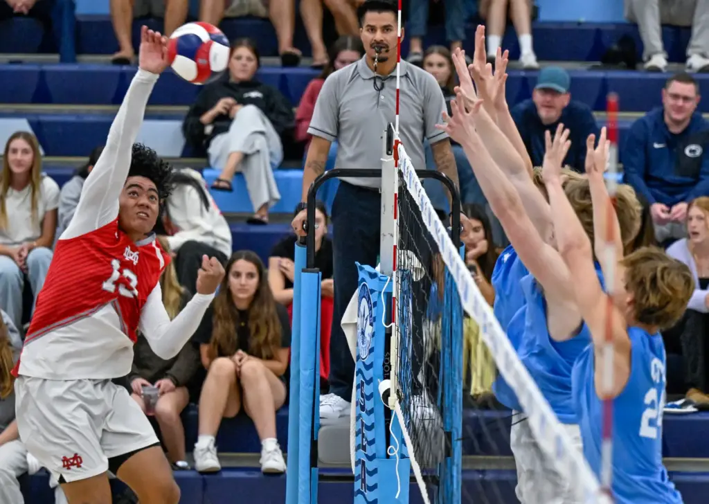 Mater Dei outside hitter Jeremiah Potasi hits the ball during...