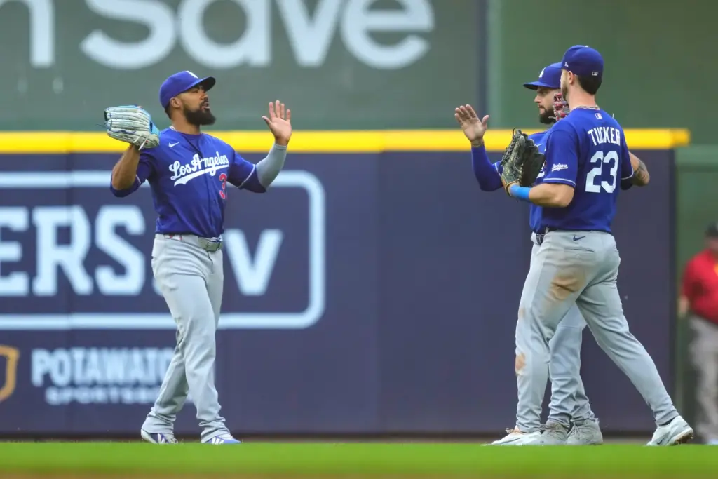 Dodgers left fielder Teoscar HernÃ¡ndez, left, reacts with teammates Andy...