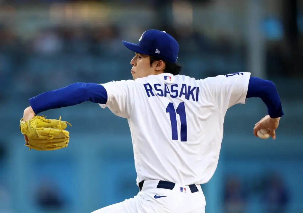 Dodgers starting pitcher Roki Sasaki throws to the plate during...