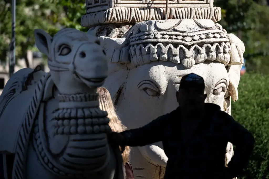 A worker waits to move giant chess pieces into position...