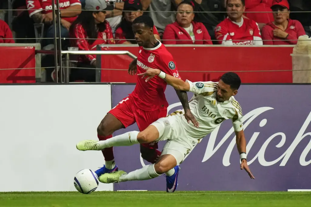 LAFC’s Mark Delgado, right, challenges Toluca FC’s Helinho during the...