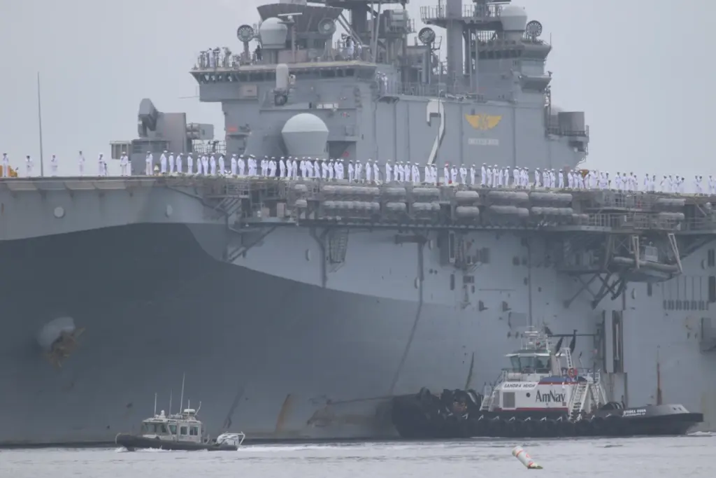 Sailors man the rails as the USS Essex arrives in...