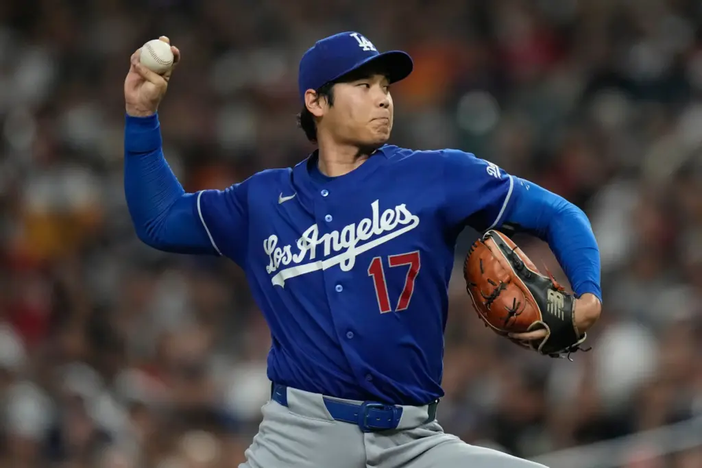 Dodgers starting pitcher Shohei Ohtani throws to the plate during...