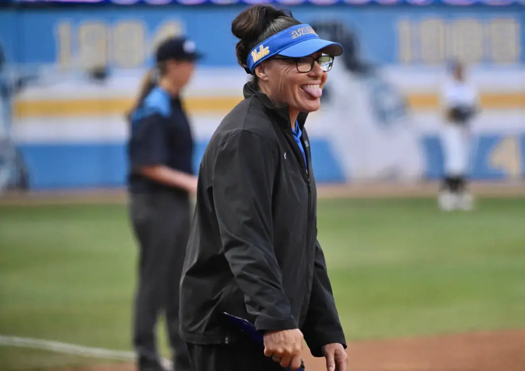 Third base coach Lisa Fernandez of the UCLA Bruins reacts...