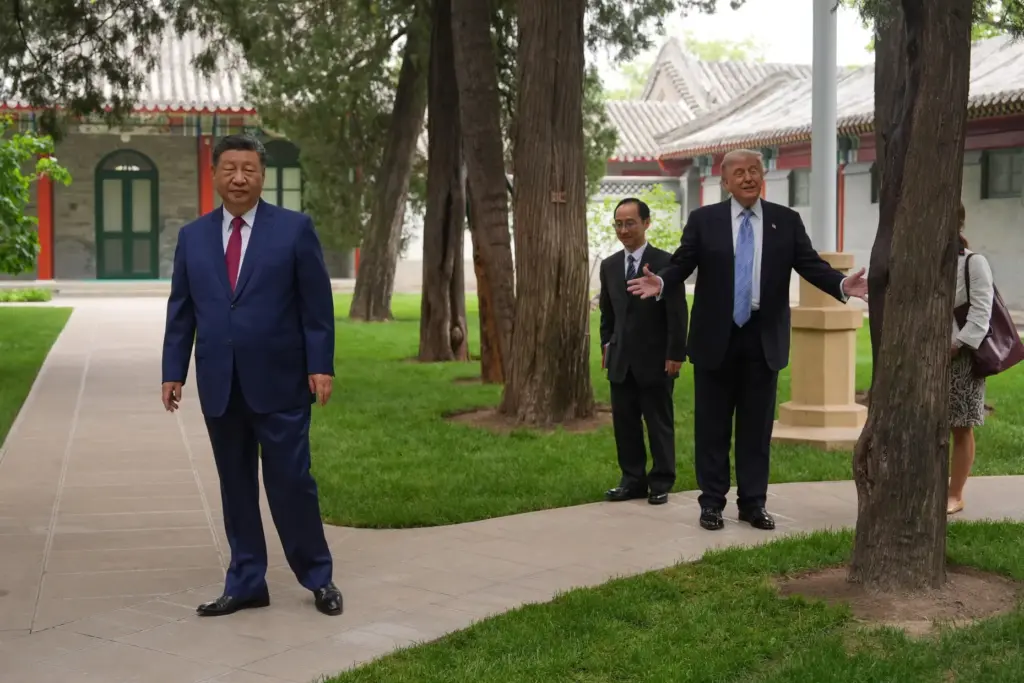 President Donald Trump walks with China's President Xi Jinping.