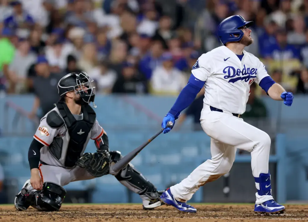 The Dodgers’ Max Muncy watches the flight of his solo...