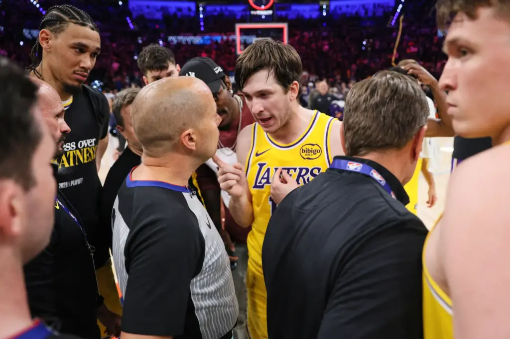 Los Angeles Lakers’ Austin Reaves, center right, talks with referee...