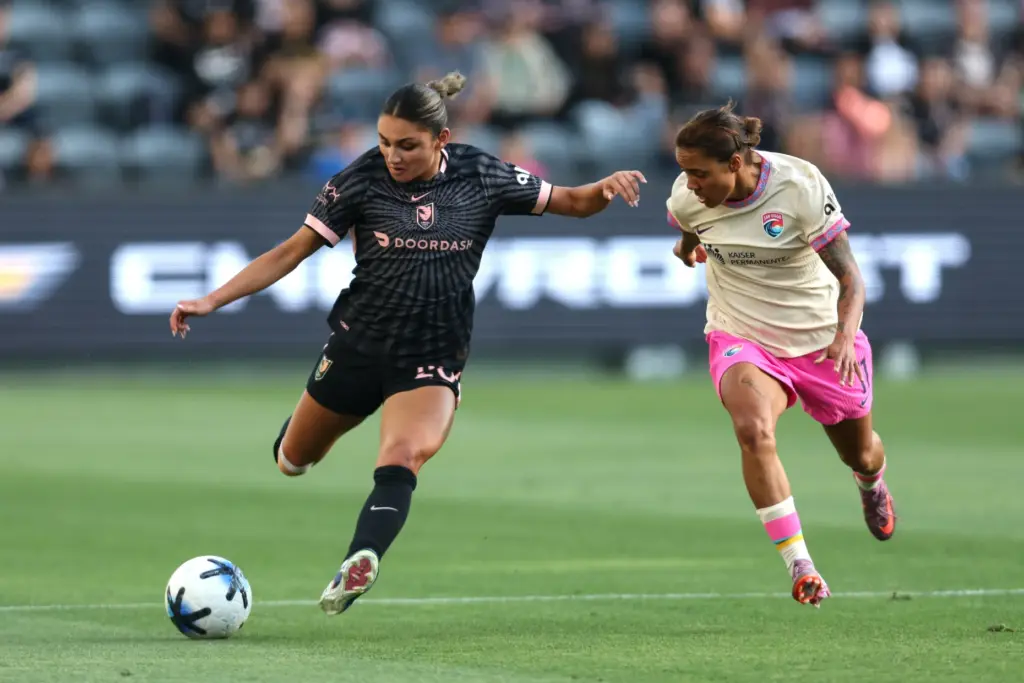 Angel City FC defender Gisele Thompson, left, winds up to...