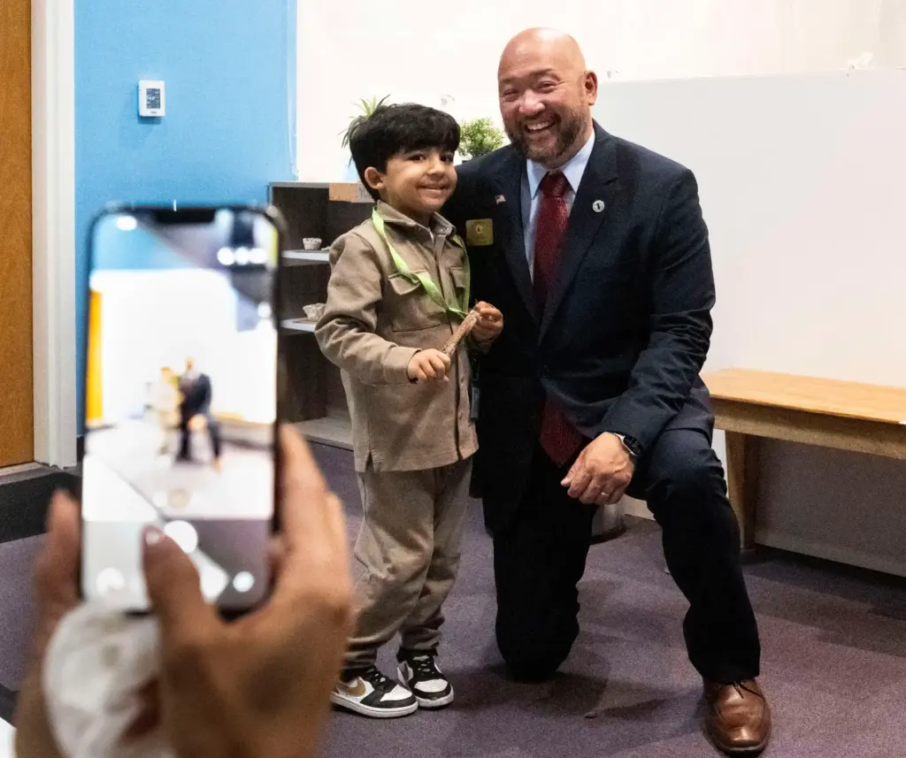 Zayn Sarwari, 4, takes a photo with Irvine Vice Mayor...