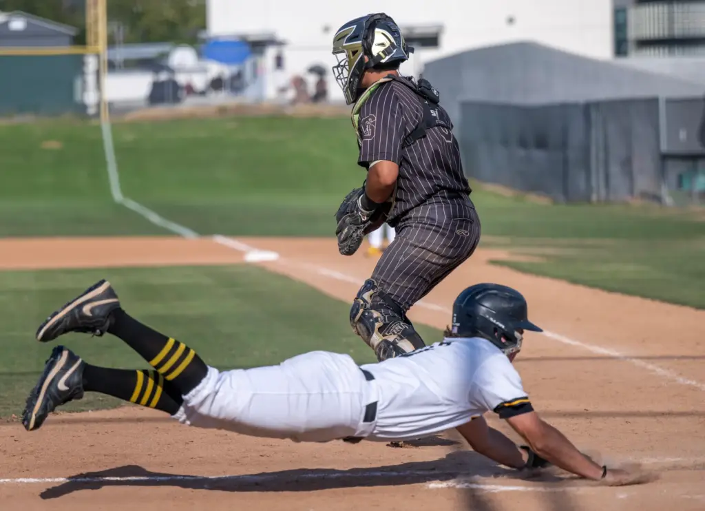 Foothill outfielder Maddux Blevins slides into home plate to score...