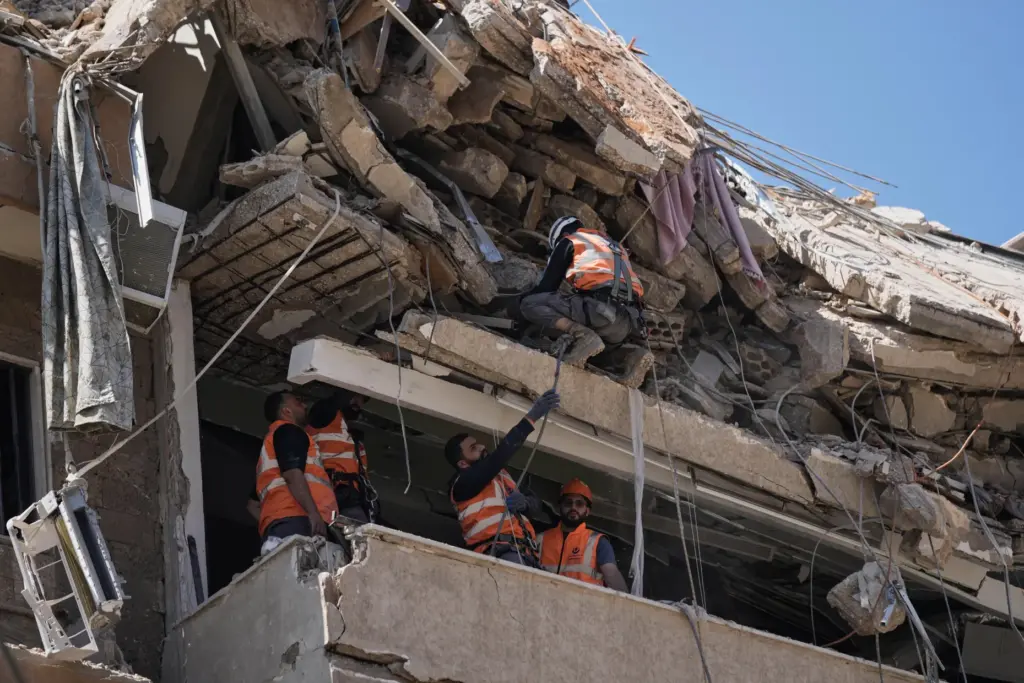 Rescue workers search through the rubble of a building destroyed in an Israeli airstrike in Lebanon.