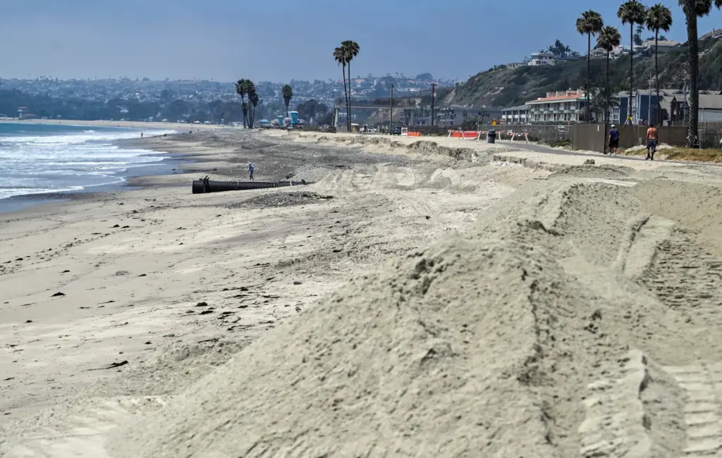 The first of 13,500 cubic yards of sand is delivered...