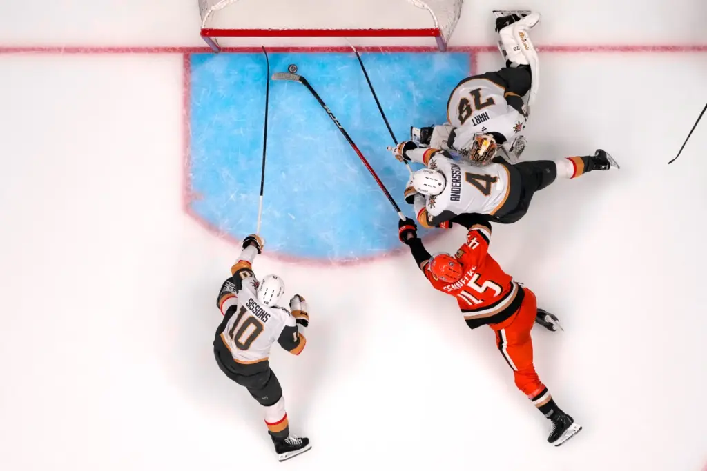 Ducks right wing Beckett Sennecke, second from left, scores as...