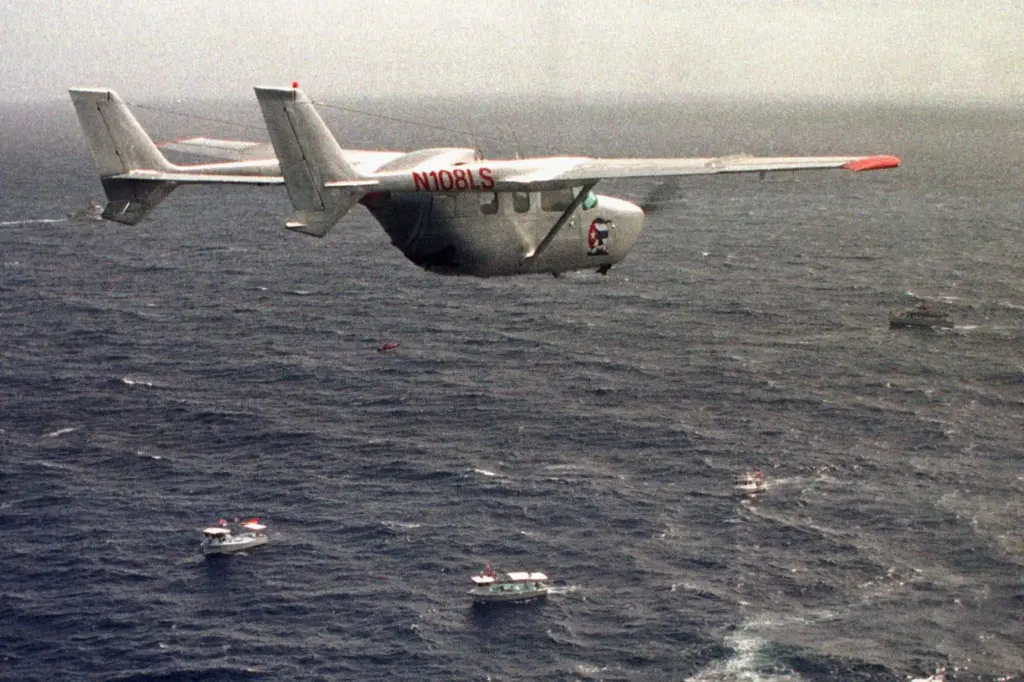 FILE – A Brothers to the Rescue plane flies over...