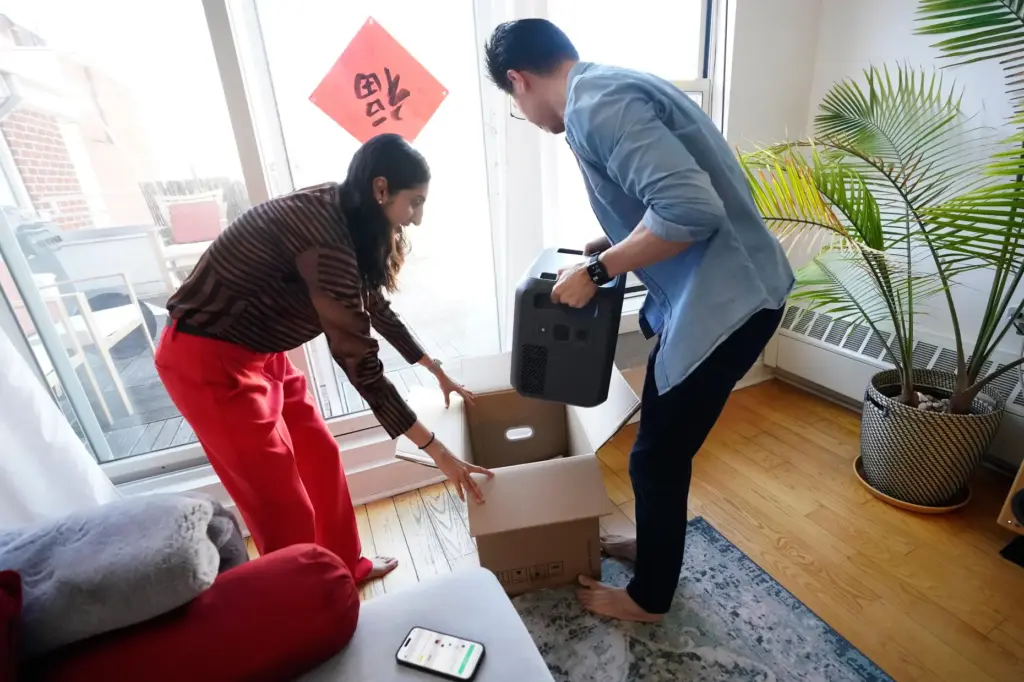Sonam Velani and Yan Sim plug unbox a battery from Every Electric to power an air conditioner