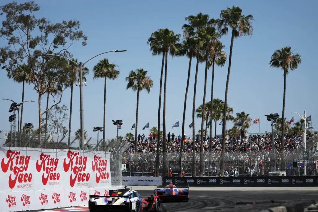 GTP cars hustle around the track in the IMSA race...