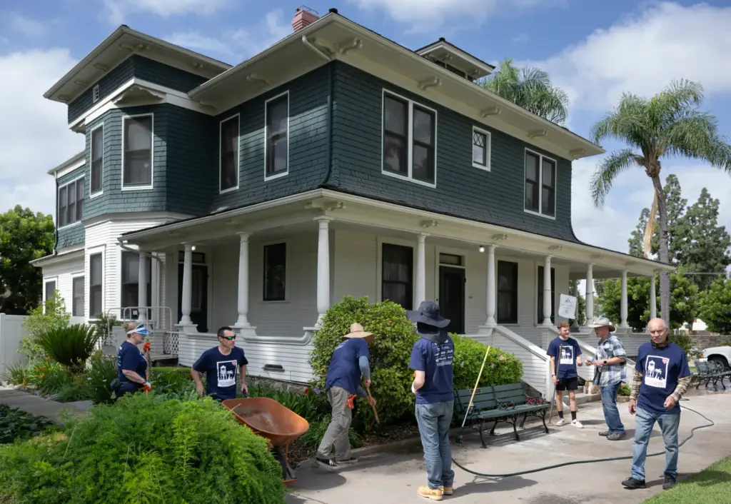 Love Placentia volunteers work on landscape outside the historic Bradford...
