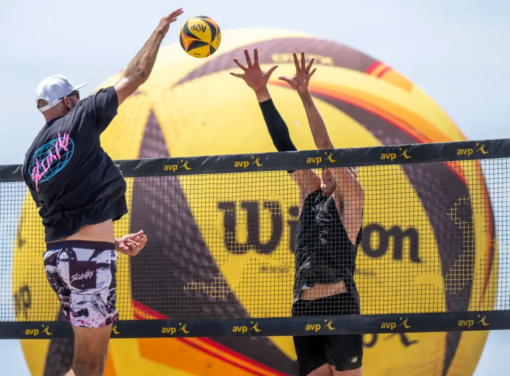James Shaw, right, blocks a spike by Phil Dalhausser in...