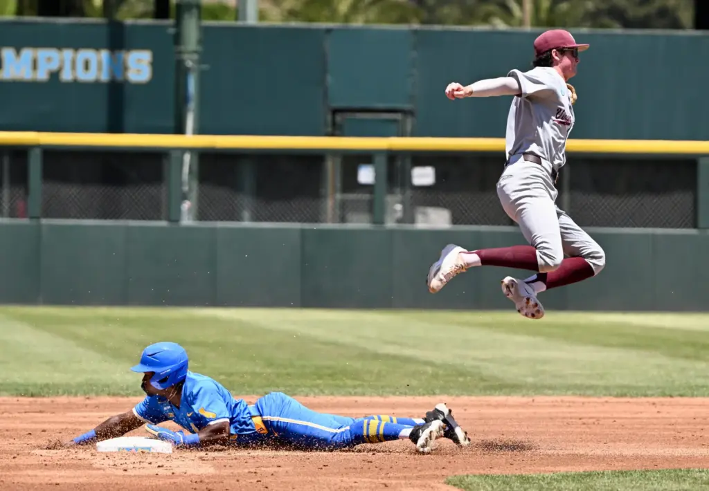 Dean West #36 of the UCLA Bruins steals second base...