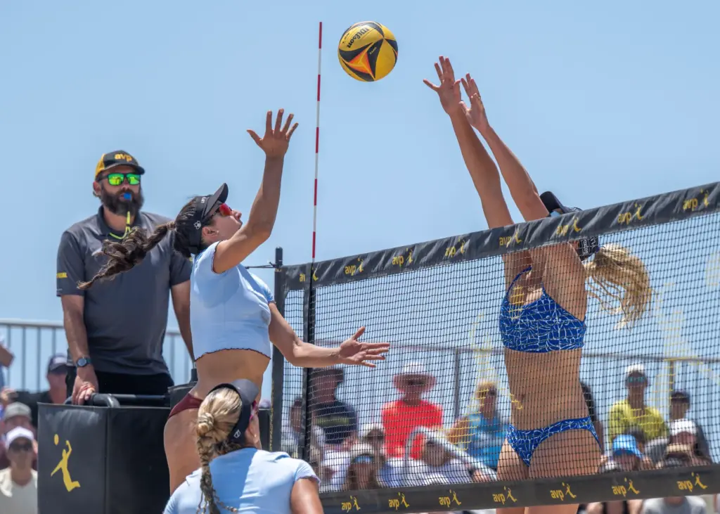 Melissa Humana-Peredes, left, hits the ball while Taryn Brasher puts...