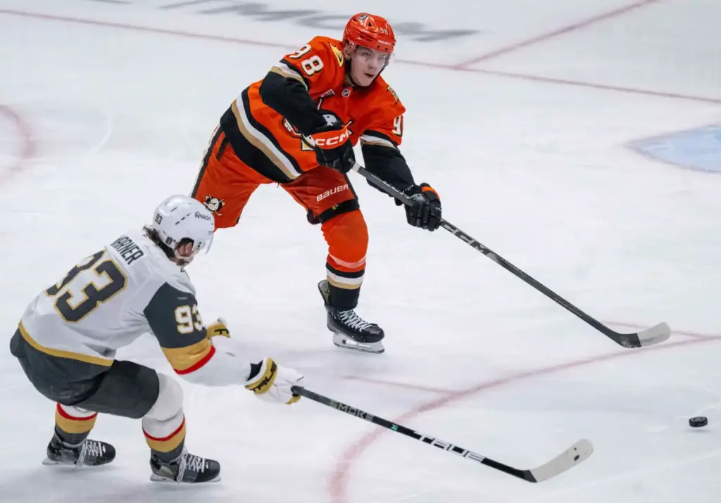 The Ducksâ Pavel Mintyukov, top, shoots the puck as the...