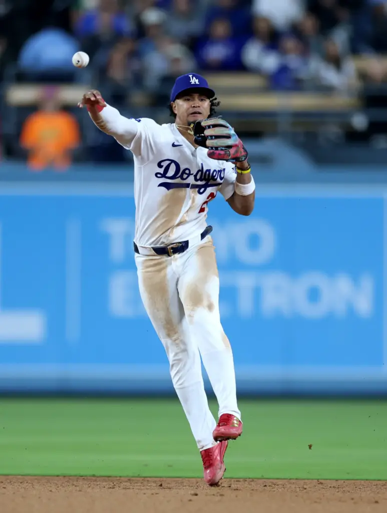 Dodgers second baseman Santiago Espinal throws to first for a...